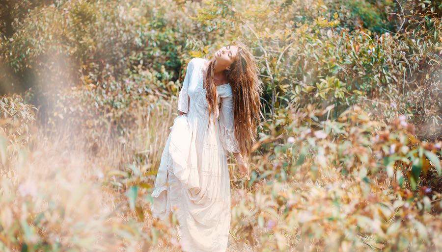 Woman in white Dress Dancing in Field